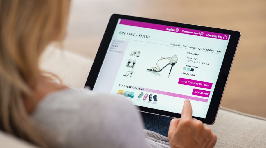 A woman browsing an online store, shopping for shoes.